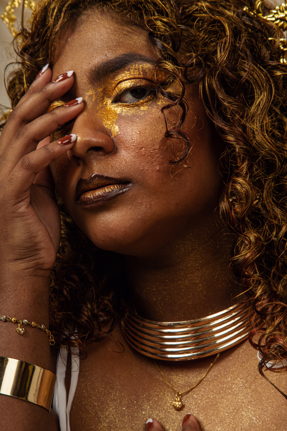 Portrait of a Woman in Gold Makeup and Accessories